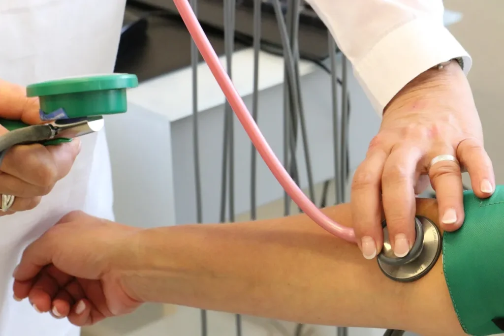 Health insurance: Doctor, examination and blood pressure