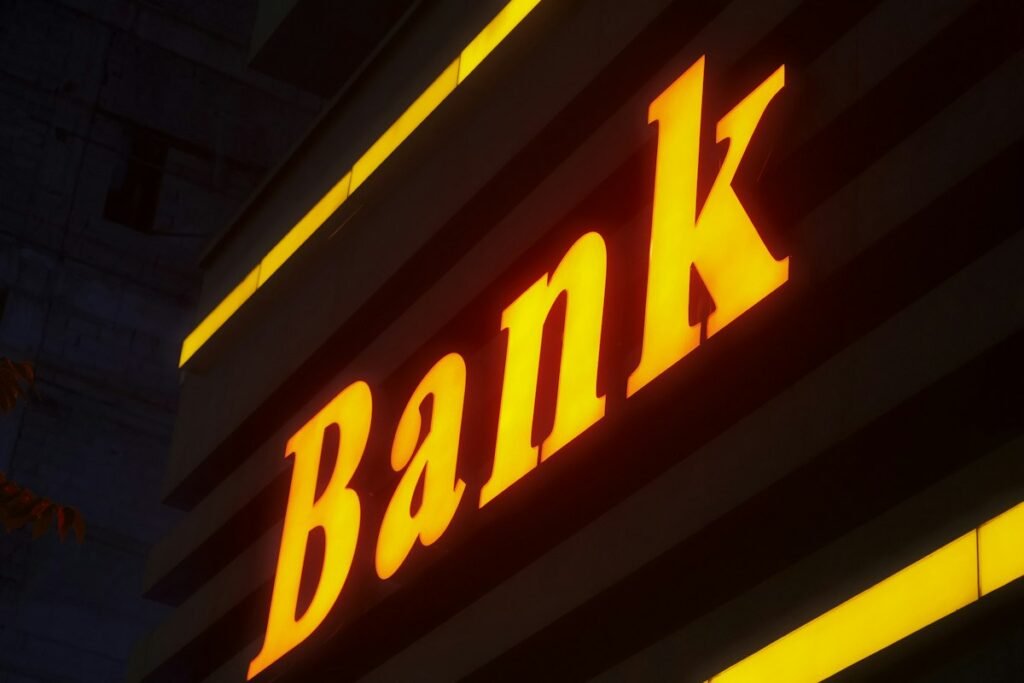 Abank sign lit up in the dark