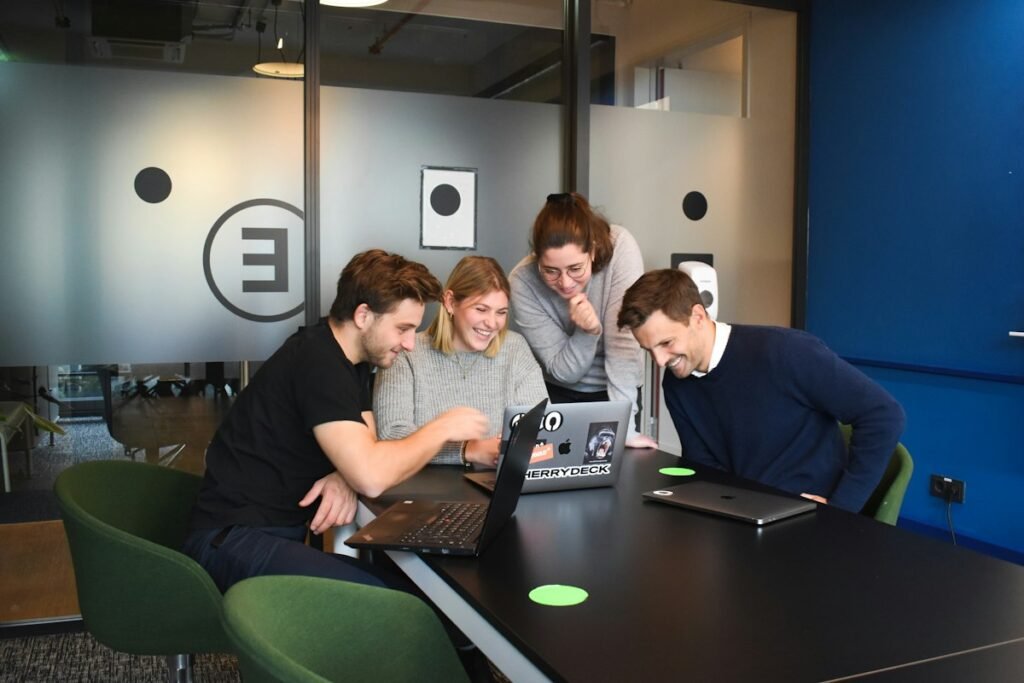 People sitting on chair in front of laptop computers